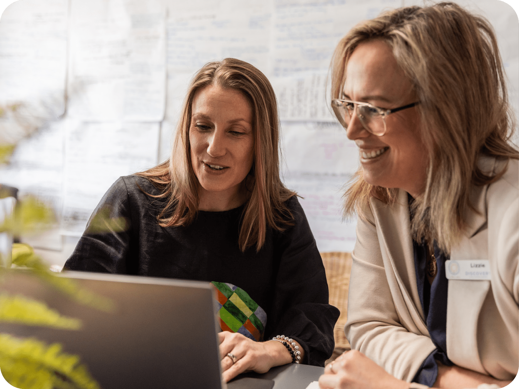Two educators looking at a laptop